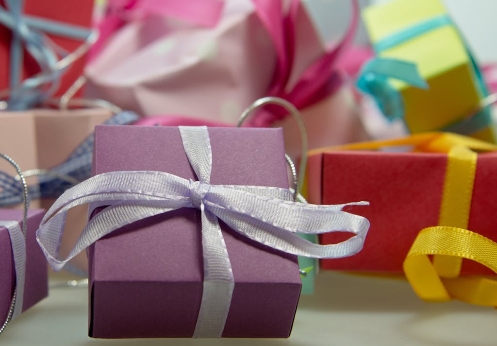 Vivid assortment of gift boxes adorned with ribbons in a detailed close-up shot.